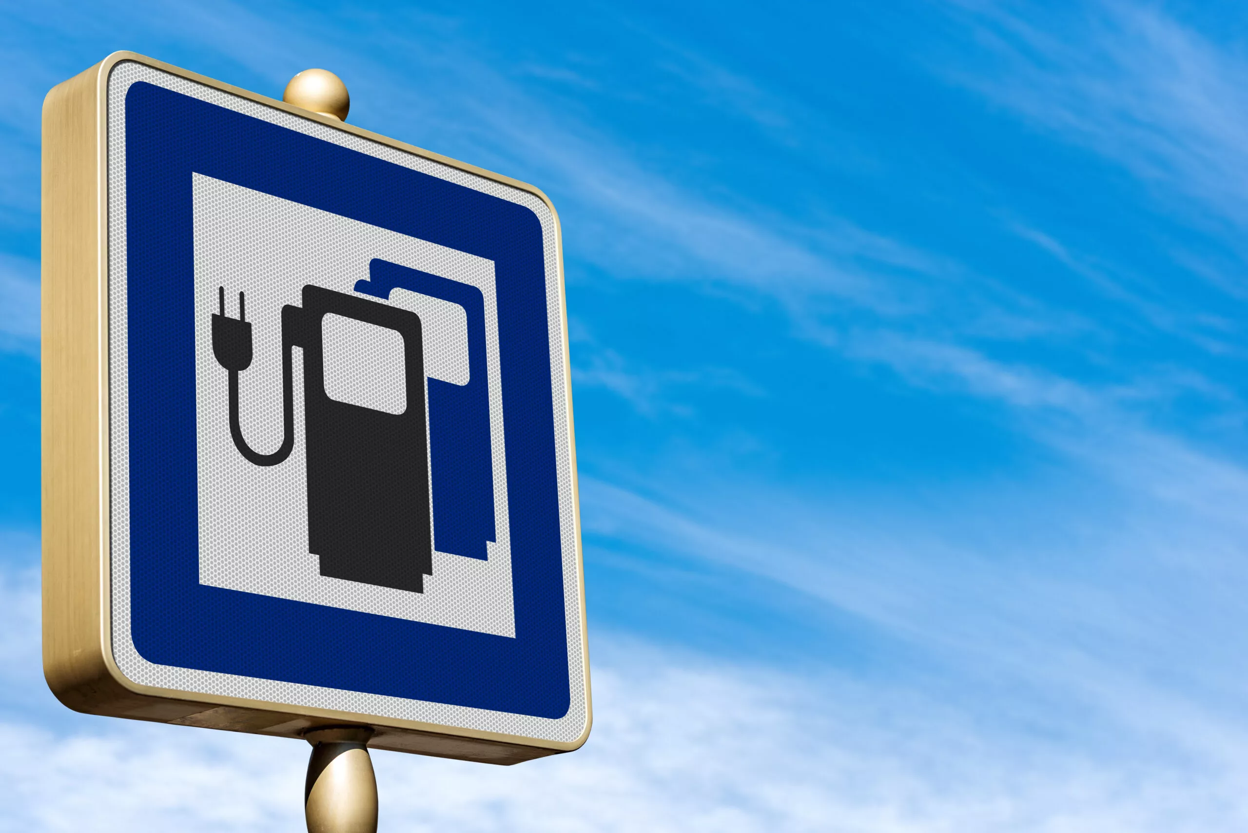 Road sign for an Electric Vehicle Charging Station on Blue sky w